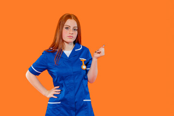 Young woman in a blue uniform stands confidently against an orange background, showcasing her...