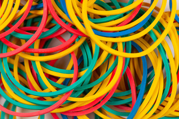 Many colorful rubber bands on a white background. Abstract background of seamless lines.