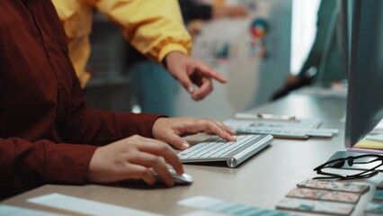 A modern workspace featuring hands typing on a keyboard, embodying collaboration and creativity. Colleagues engage in discussion while brainstorming ideas and strategies. SACTR