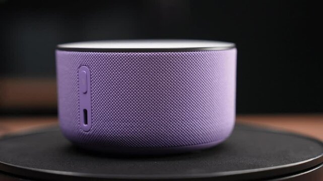 Moscow, Russia - March 13, 2025:Purple Yandex Station Mini 3 Rotating on Black Stand