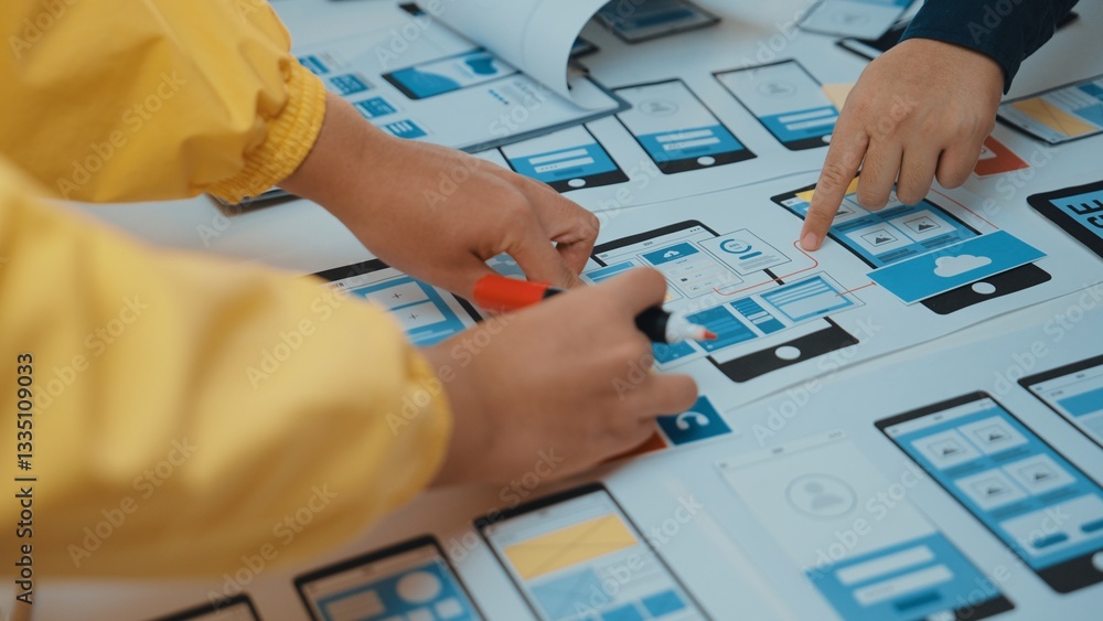 Poster a dynamic creative session showcases hands collaborating on a mobile app design. colorful sketches a