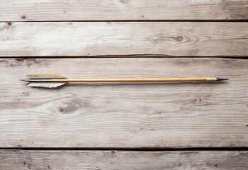 Old wooden arrow resting on rustic wooden planks