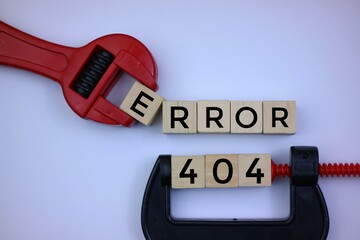 Error 404 message on wooden cubes with red wrench on white background.