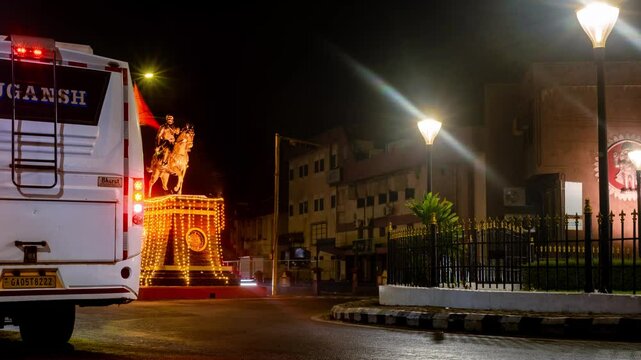 4k Hyperapse Timelapse Night footage of Mapusa City in Goa with traffic light trails of vehicles and statue of Shivaji Maharaj
