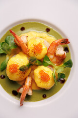 Shrimp soup with herbs and vegetables, served in a bowl. Fresh seafood cuisine with aromatic broth.