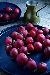 Radish on the black plate and wooden table.