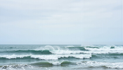 Fototapeta premium Wild waves crashing on a windy day at the beach, nature's power