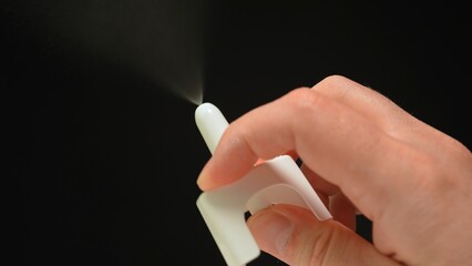 Naloxone nasal spray is life-saving medication used to reverse opioid overdose by quickly restoring normal breathing, isolated view on black background.