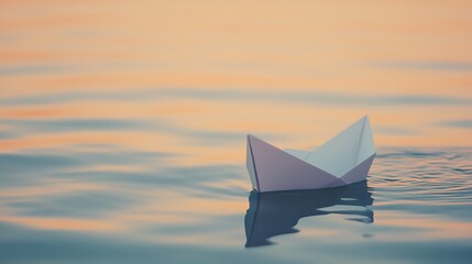 Obraz premium A delicate paper boat floats gently on a tranquil lake at sunset. Soft, warm colors and calm water create a peaceful scene