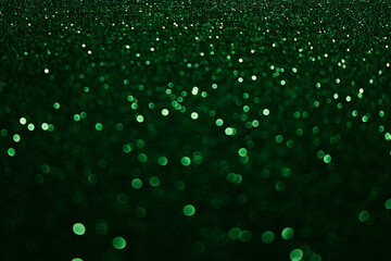 An out of focus, shallow depth of field photograph of a pale light multicolour abstract glittery surface, with vibrant neon light against a black background. Bokeh lights background