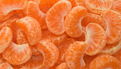 Slices of ripe tangerine background top view