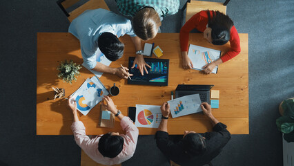 Top down view of business woman explain and present financial chart. Diverse group discuss and...