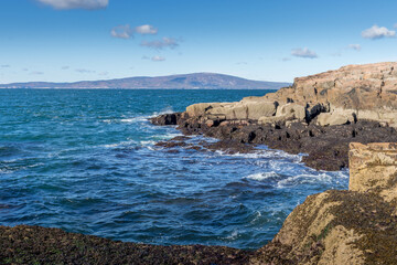 rocky coastline with island in the background