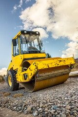 road roller, machine, heavy equipment, road construction, aggregate, ballast, construction work, yellow, perspective, vertical, photo, blue sky, machinery, roller