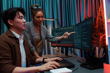 IT developers discussing with point to intelligent website development coder system running data...