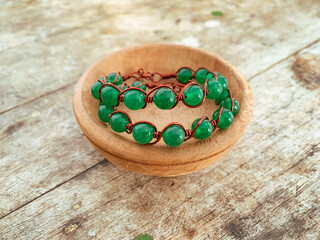 handmade wire copper bracelet on wooden table
