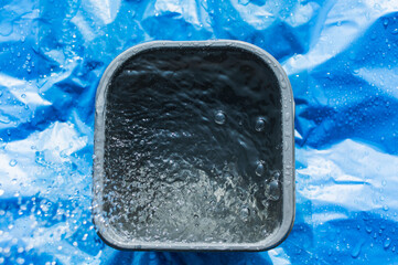 Splashes of water pouring from the watering tap