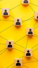 Social Network Concept with Connected Wooden Blocks on Yellow Background