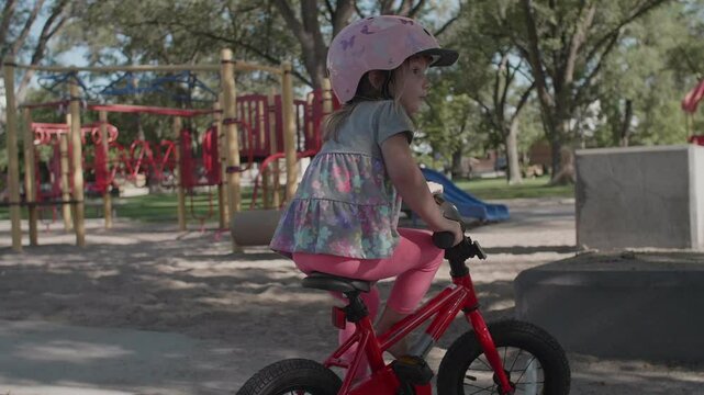 Little Girl Dismounting a Bike in Slow motion