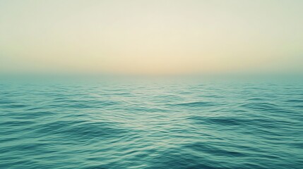 Fototapeta premium A serene view of calm ocean waters meeting a soft horizon at dawn.