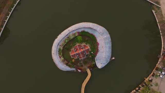 Drone perspective of Sumeru Mountain temple above calm waters. Aerial drone video