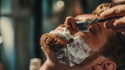 Naklejka premium Young caucasian male enjoying relaxing shaving experience at barbershop
