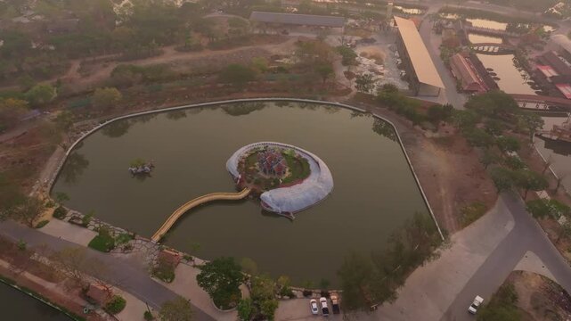 Drone shot of Sumeru Mountain temple glowing at sunrise, Bangkok. Aerial drone video