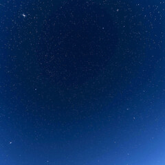 Fototapeta premium Glimpses of Celestial Harmony: Stars Illuminating the Starry Night Sky