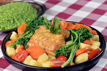 codfish typical Portuguese dish baked cod with onion garlic peppers and potatoes rustic Portuguese food salted fish cooked olive oil