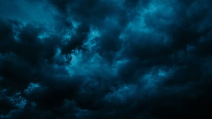 Night sky with clouds. Black dark petrol blue tone. Dramatic background. Storm thunder rain cloudy gloomy. Moonlight midnight. Scary creepy ominous.