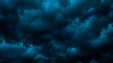 Night sky with clouds. Black dark petrol blue tone. Dramatic background. Storm thunder rain cloudy gloomy. Moonlight midnight. Scary creepy ominous.