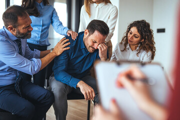 Support Group Counseling Session with Team Comforting a Distressed Individual