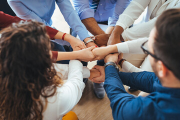 Diverse Team of People Uniting Hands in a Symbol of Collaboration
