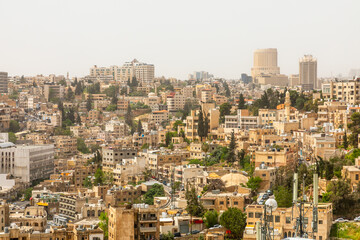 Fototapeta premium Lots of residential houses densily scattered on the hills in the downtown of Amman city, Kingdom of Jordan