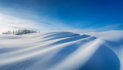 serene winter landscape with soft curves of snow and gentle light above in a tranquil blue sky atmosphere