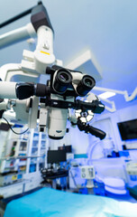 Neurosurgery gear in OR. Advanced surgical microscope in a sterile OR, showcasing precision for a neurosurgery procedure.