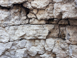 Natural rocky surface with intricate patterns and textures in beige tones, beauty of geological formations
