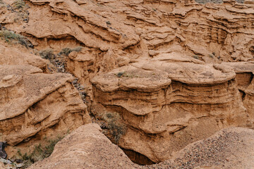 Exploring the captivating geological formations in Kyrgyzstan's rugged landscapes under a clear blue sky