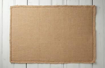 Top view brown burlap tablecloth on white wooden background. Empty space for design. Background natural, eco friendly material with rustic texture. Great for food photos or handmade promo content.