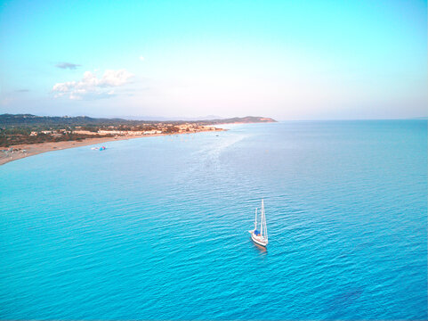 Magnificent drone areal view of sailboat on blue sea under blue skies