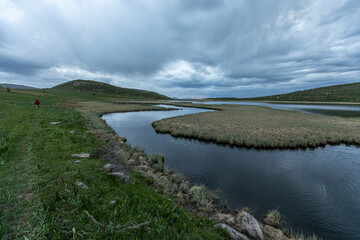 Hayeli (Mirror) Lake near Artavan village, Vayots Dzor, Armenia, is a stunning alpine lake reflecting the dramatic sky. It replicates world map. A popular destination for hiking, trekking and camping 