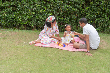 Family sharing a picnic in the garden