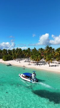 Drone view of Saona Island, turquoise waters, white sand, boats and a pure tropical paradise in the Dominican Republic.