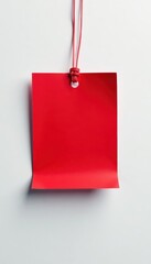 Red rectangular tag affixed to pristine white surface, vibrant, tag, warning