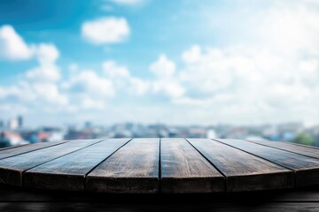 Empty round wooden table outdoors with a city skyline and blue sky background