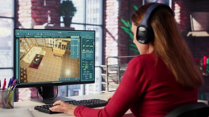 Professional architectural designer configures a floor plan on dual monitors, utilizing computer aided design tools. Woman uses digital rendering and interior decoration remodeling. Camera A.