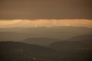 Mount Hood and surrounding forests partially obscured by thick wildfire smoke, seen from Jonsrud Viewpoint in Sandy, Oregon. The 2020 wildfires created hazardous air and eerie skies