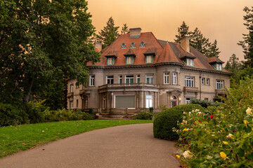 Pittock Mansion in Portland, Oregon, under an orange-tinted sky caused by thick wildfire smoke from the devastating 2020 fires, highlighting environmental disaster effects