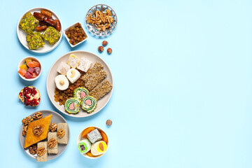 Composition with different Eastern sweets for Ramadan celebration on color background