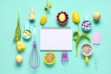 Composition with blank notebook for recipes, baking tools, Easter eggs and colorful sprinkles on color background
